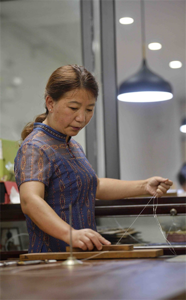 Héritière de l'art du filament d'argent tournoyant à Chengdu dans le Sichuan 