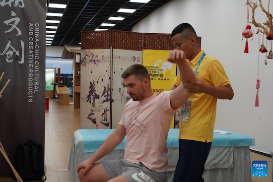 Un athlète fait l'expérience d'un massage de médecine traditionnelle chinoise (MTC) au village des Jeux de la FISU à Chengdu, capitale de la province du Sichuan (sud-ouest de la Chine), le 2 ao?t 2023. (Tang Wenhao / Xinhua)